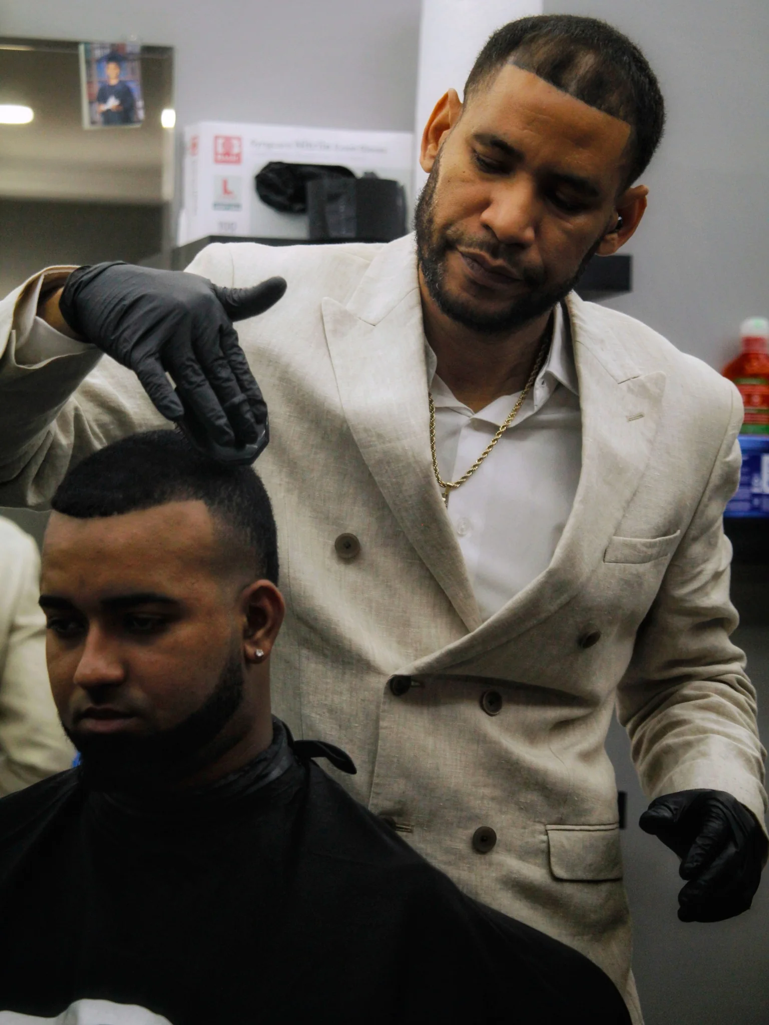 Barber standing with a seated client