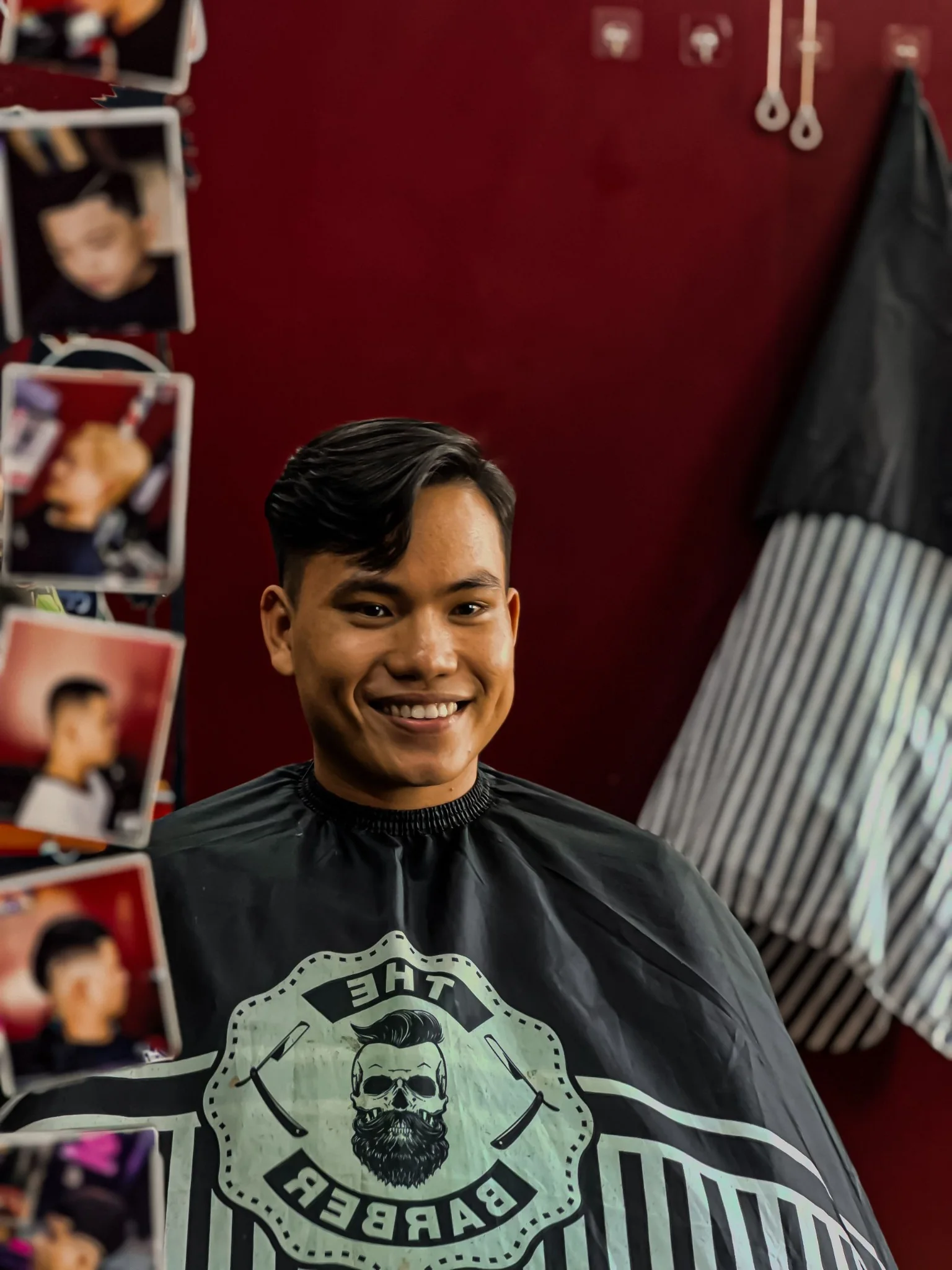 Smiling barber client seated after a haircut