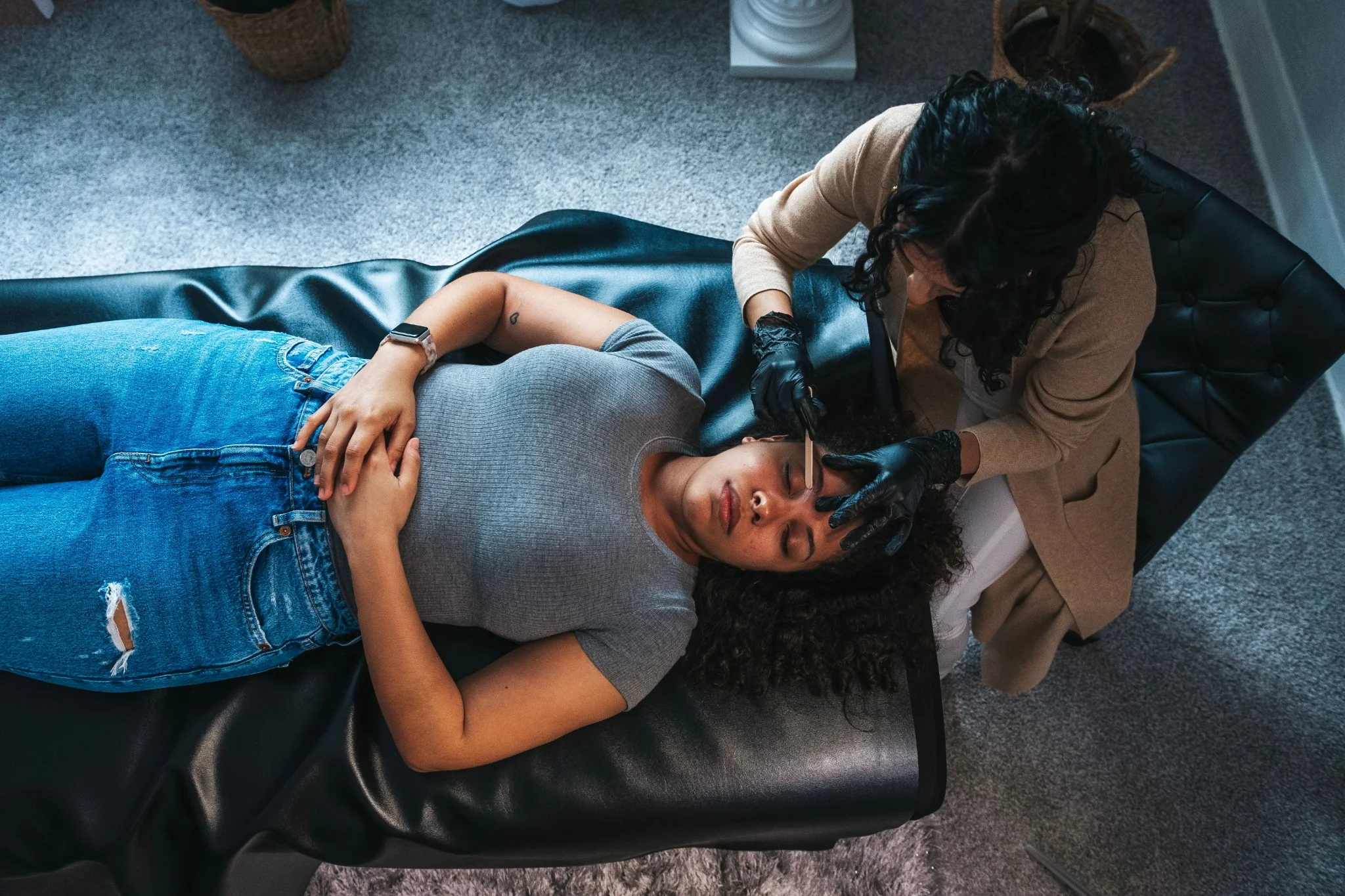 Brow specialist performing a beauty treatment for a client.