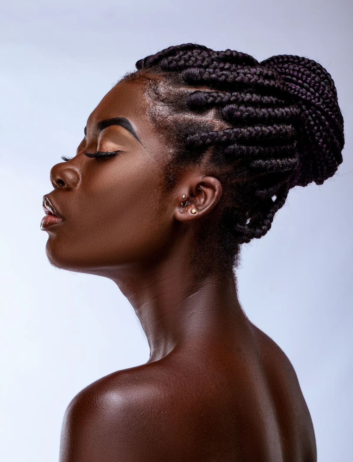 Woman with braided hair styled in an updo.