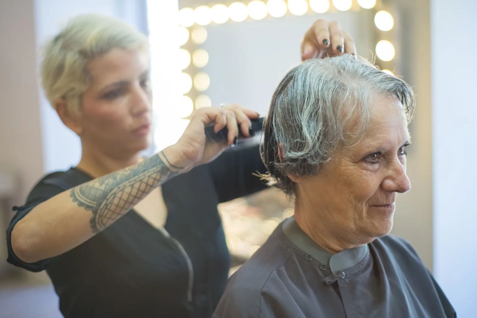 Hair stylist working with a senior client