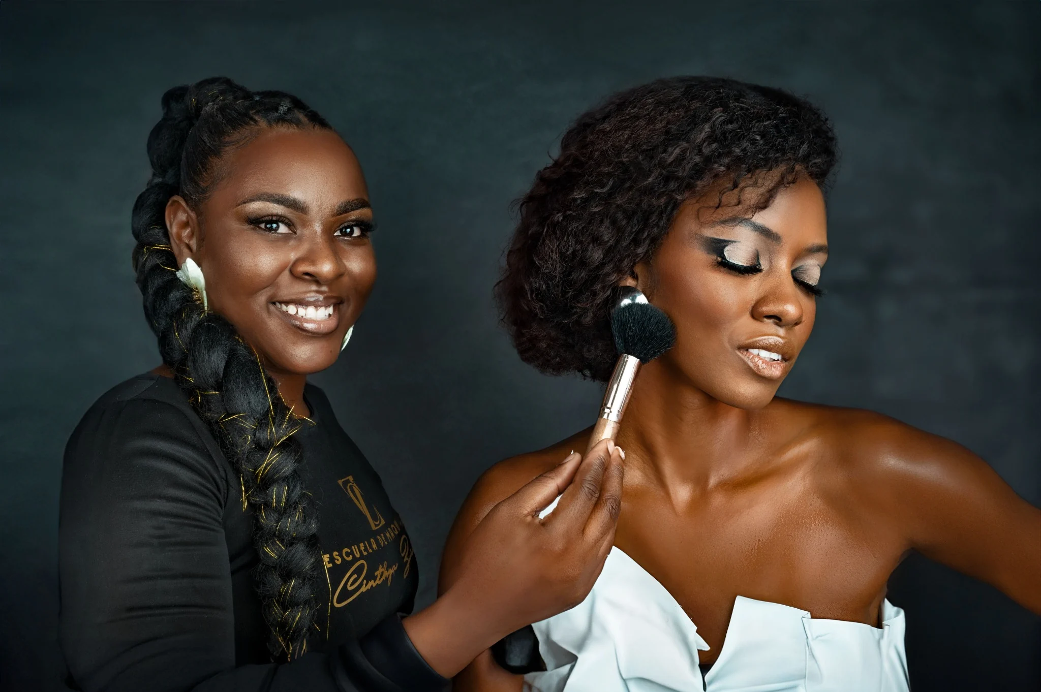 Makeup artist applying finishing touches to a client's makeup