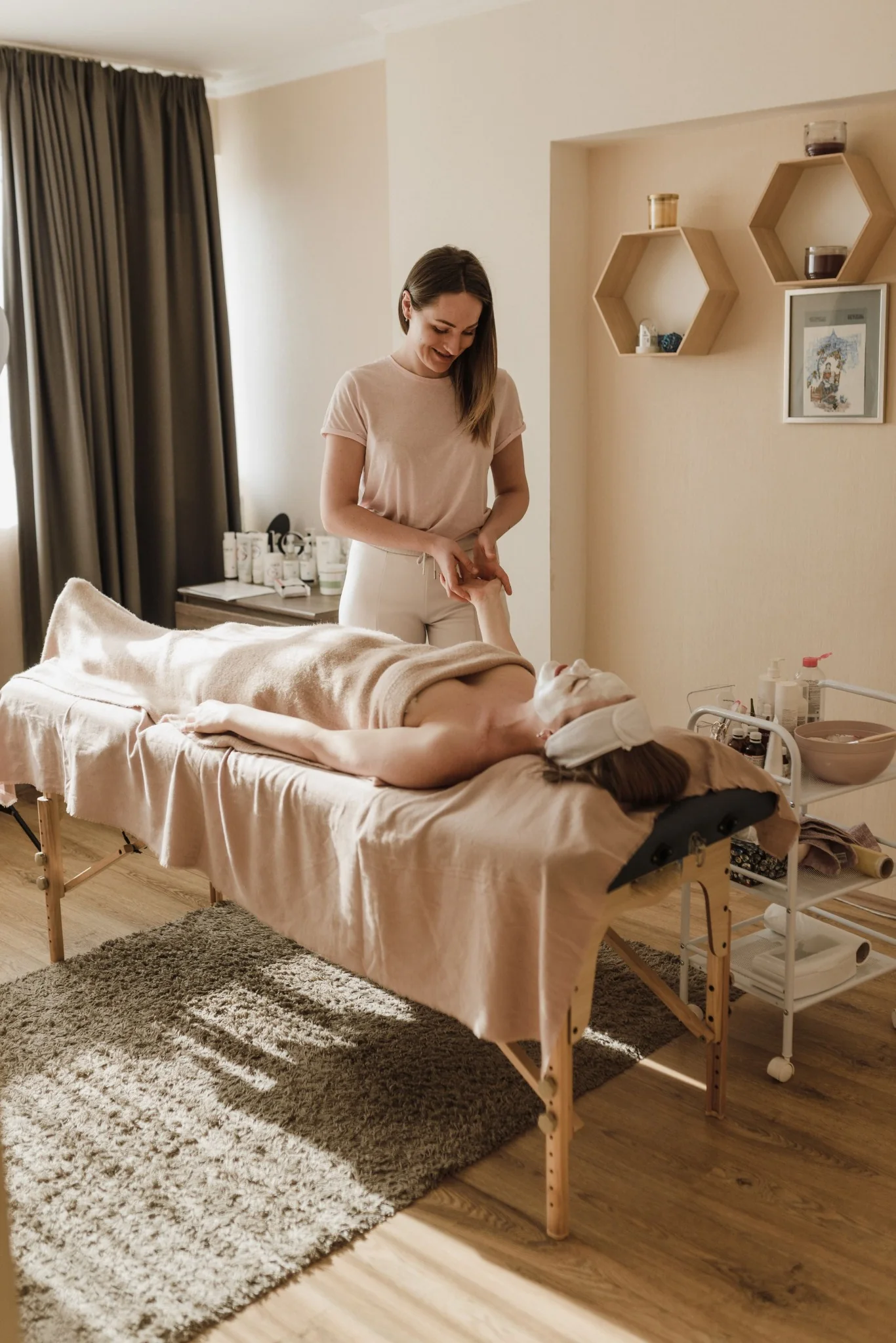 Massage therapist working with a client in a calm treatment room.